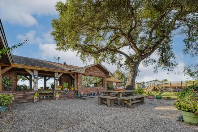 a view of a wooden bench sitting in middle of a yard