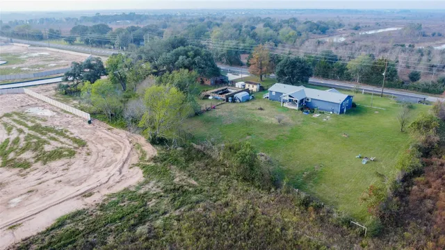 an aerial view of a house with a yard