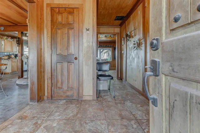 a large white kitchen with a large window and stainless steel appliances