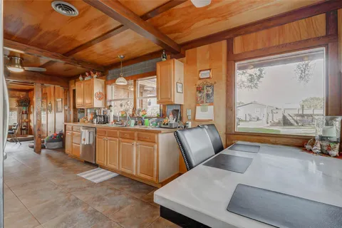 a view of a house with a yard deck and sitting area