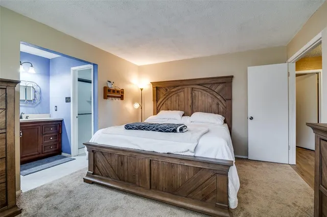 a bedroom with a bed and a view of bathroom