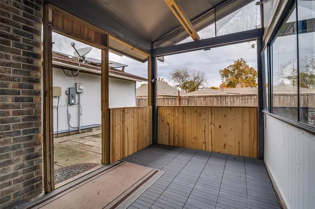 a backyard with wooden fence and a bench