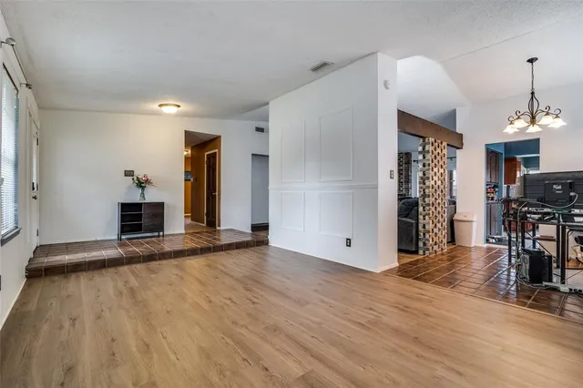 a view of a livingroom with wooden floor and a fireplace