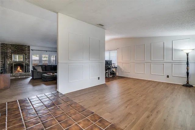 a view of a livingroom with wooden floor and furniture