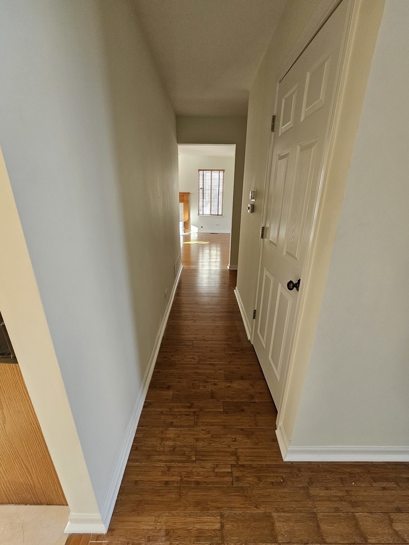 847 Teasel Lane Aurora, IL 60504 - Photo 11 of 46 a view of a hallway with wooden floor and staircase