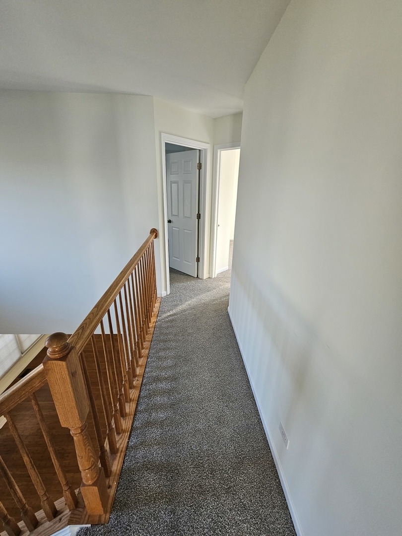 847 Teasel Lane Aurora, IL 60504 - Photo 22 of 46 a view of a hallway with a stairs