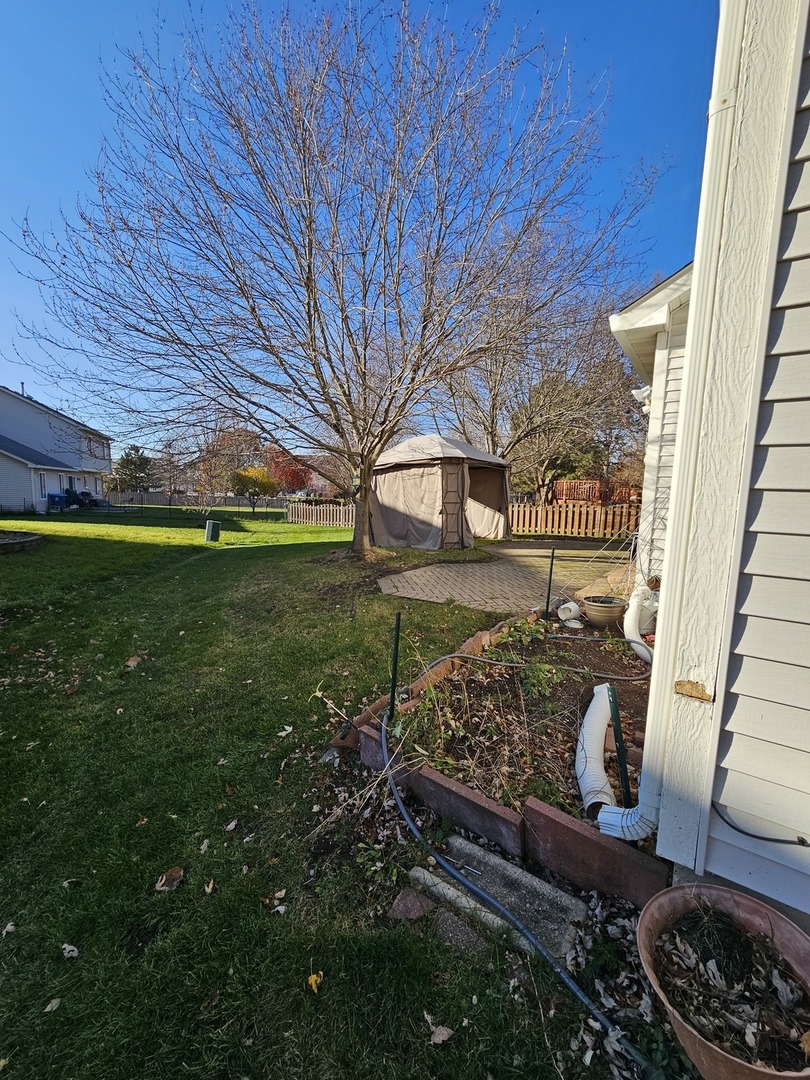 847 Teasel Lane Aurora, IL 60504 - Photo 6 of 46 a view of a backyard with plants and a garden