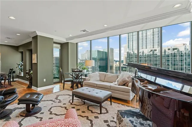 a living room with furniture fireplace and a large window
