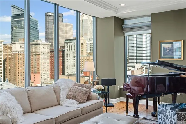 a living room with furniture and floor to ceiling window