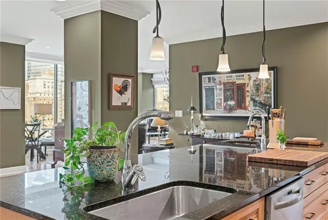 a kitchen with stainless steel appliances granite countertop a sink a stove and a refrigerator