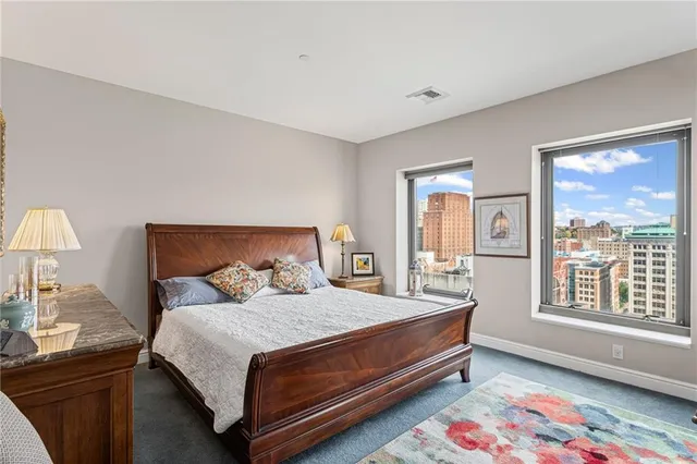 a view of a bedroom with a bed and a couch