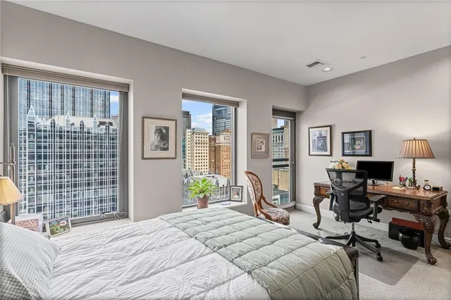 a view of a workspace with furniture and a window