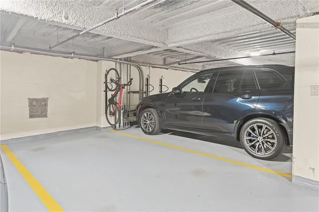 a living room with furniture a flat screen tv and a floor to ceiling window