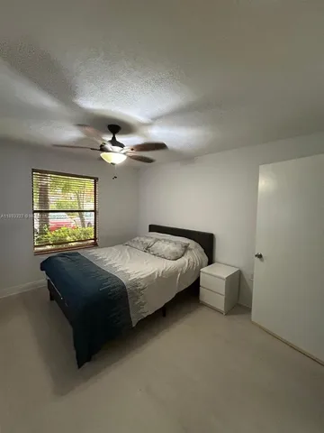 a bed sitting in a bedroom and chandelier