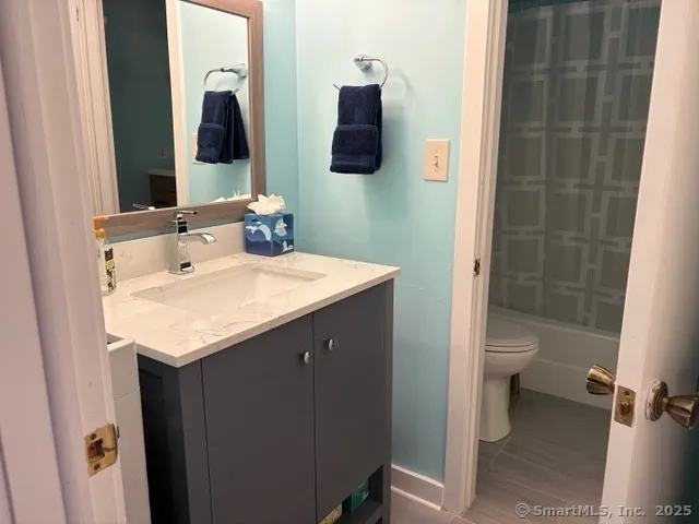 a bathroom with a sink toilet and shower
