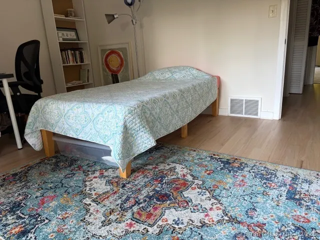 a bed sitting in a room next to a window