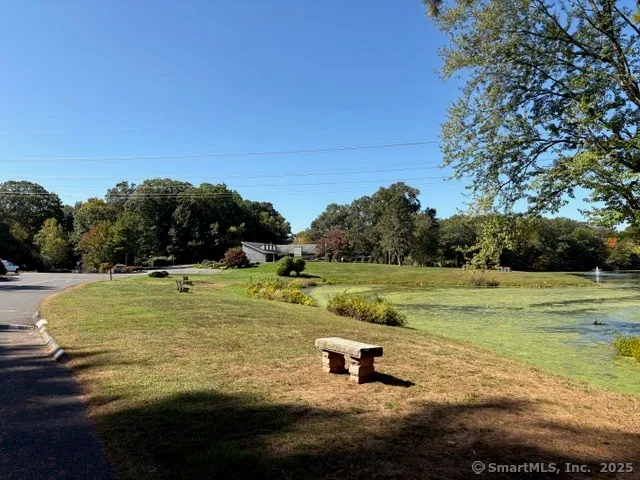 a view of a swimming pool with a yard and outdoor seating