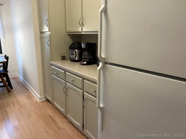 a kitchen with a sink a refrigerator and cabinets