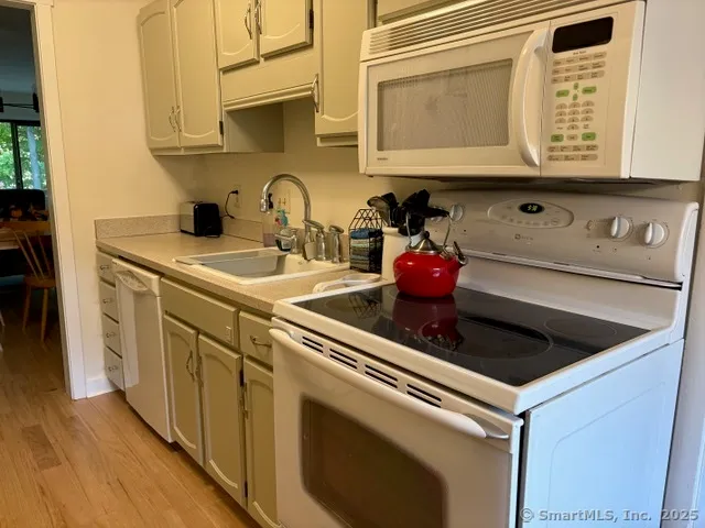 a kitchen with stainless steel appliances granite countertop a sink and a stove