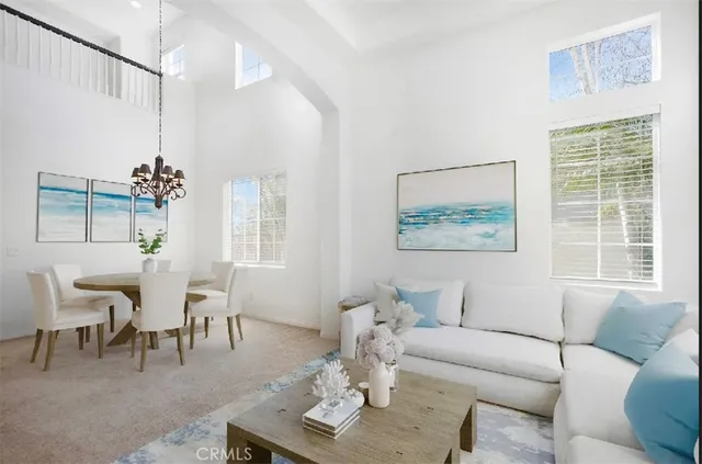 a living room with furniture a table and a window