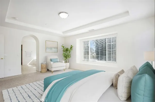 a bedroom with a bed and a large window