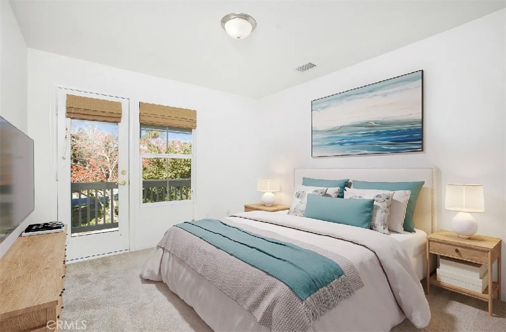 12 Avenida Reflexion San Clemente, CA 92673 - Photo 23 of 42 a bedroom with a bed and a painting on the wall