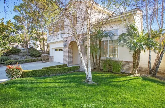 a front view of house with yard and green space