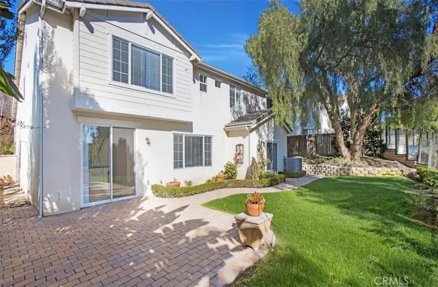 a front view of a house with a yard patio and fire pit