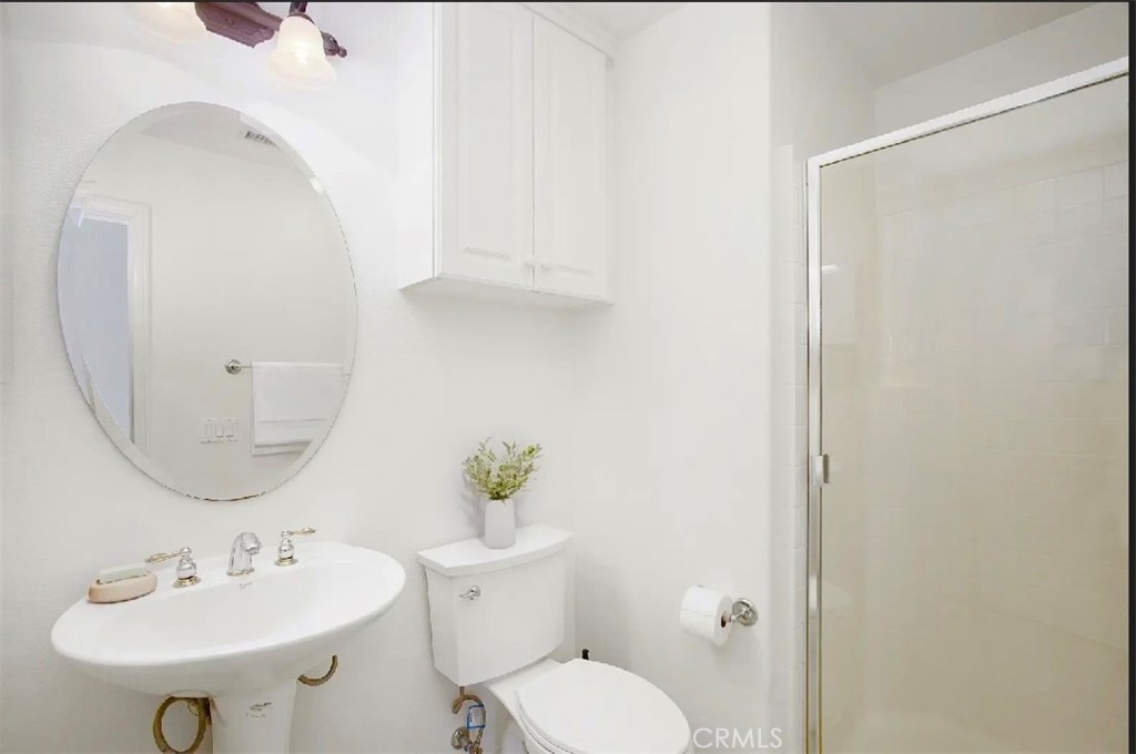 12 Avenida Reflexion San Clemente, CA 92673 - Photo 10 of 42 a bathroom with a sink a toilet and a mirror