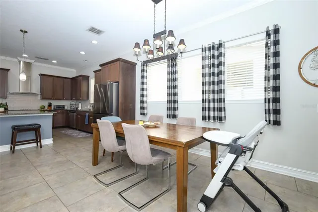 a view of a dining room with furniture and a chandelier