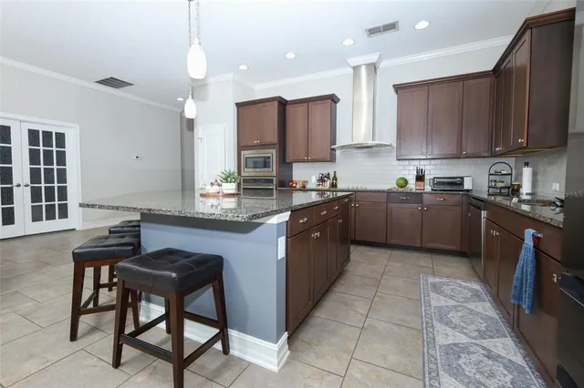 a kitchen with stainless steel appliances granite countertop a sink counter space cabinets and a window