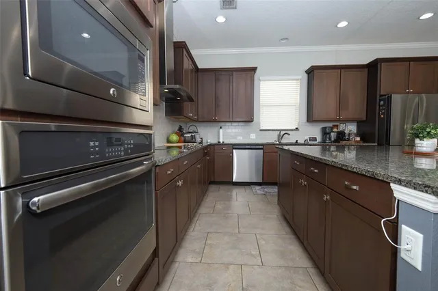 a kitchen with a sink stove and cabinets