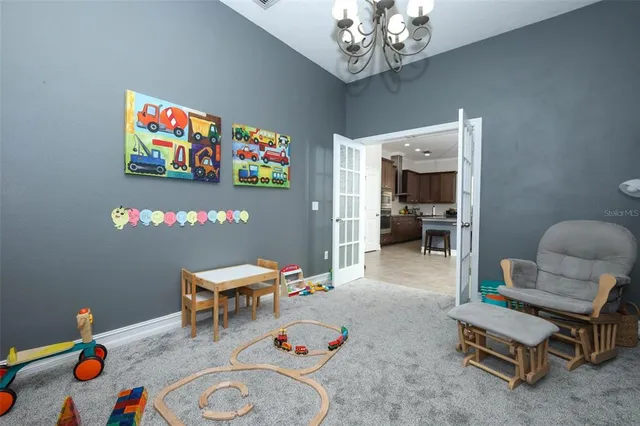 a living room with furniture and a chandelier