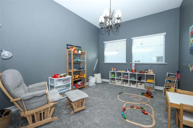 a living room with furniture a rug and wooden floor