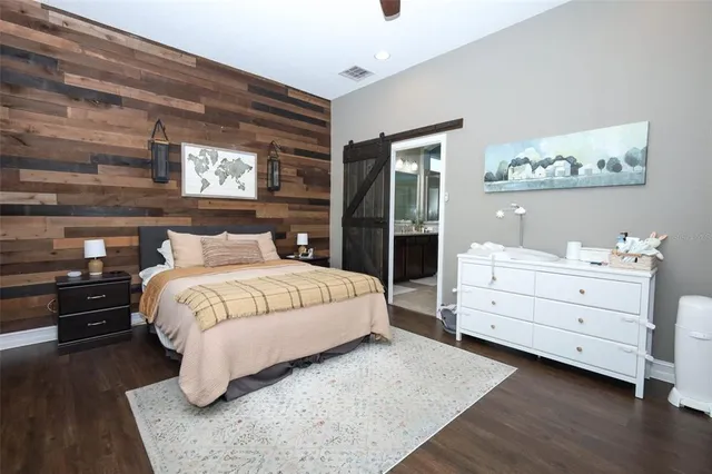 a bedroom with a bed and a night stand