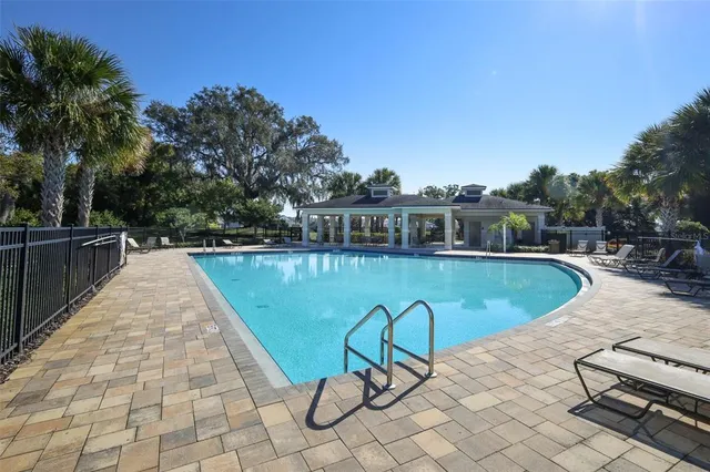 a view of swimming pool with a lounge chair