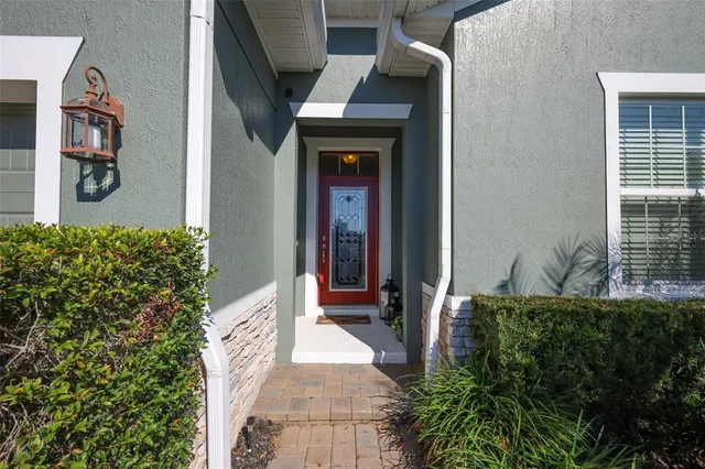 a hallway with potted plants in front of door