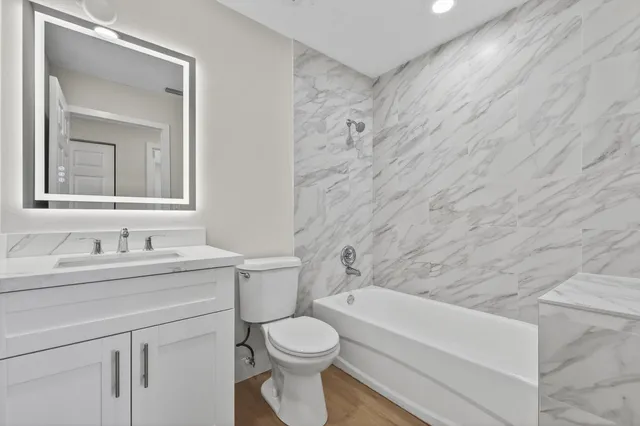 a bathroom with a sink a toilet and shower