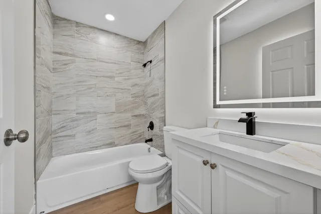 a bathroom with a sink a toilet and a bathtub