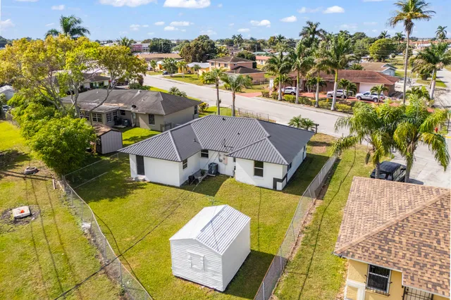 an aerial view of a house with a swimming pool