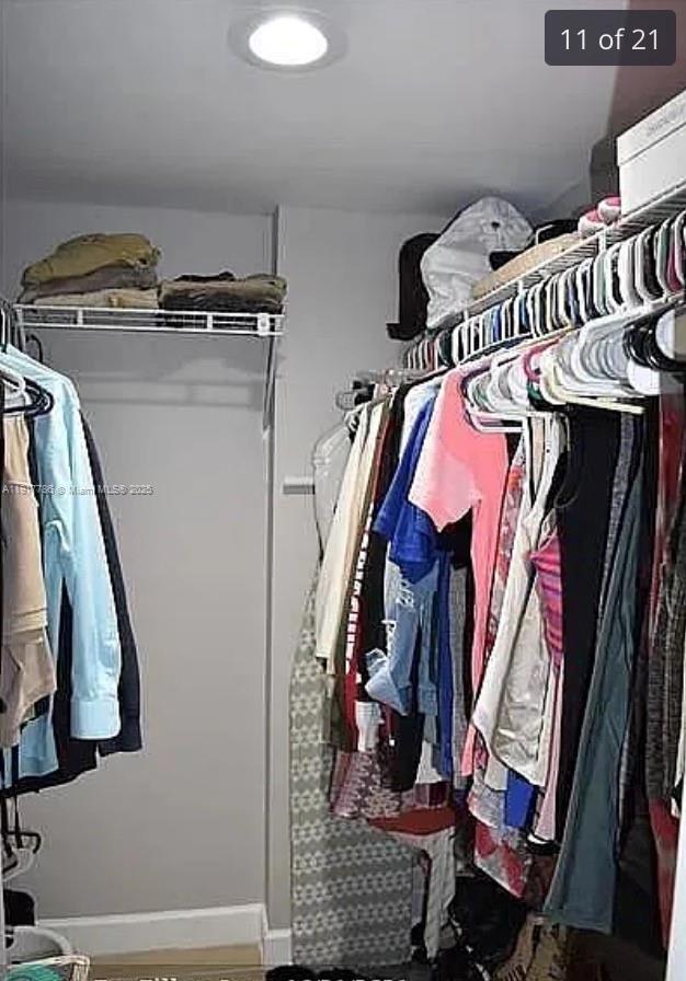 9230 Lagoon Place, Unit 215 Davie, FL 33324 - Photo 11 of 19 a view of walk in closet with clothes and shoes
