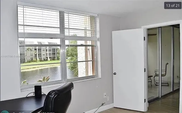 a room with a window and wooden floor
