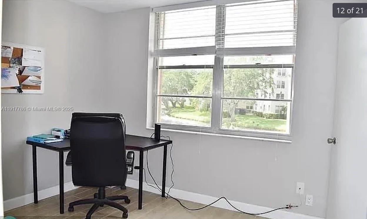 9230 Lagoon Place, Unit 215 Davie, FL 33324 - Photo 13 of 19 a view of a workspace with furniture and a window