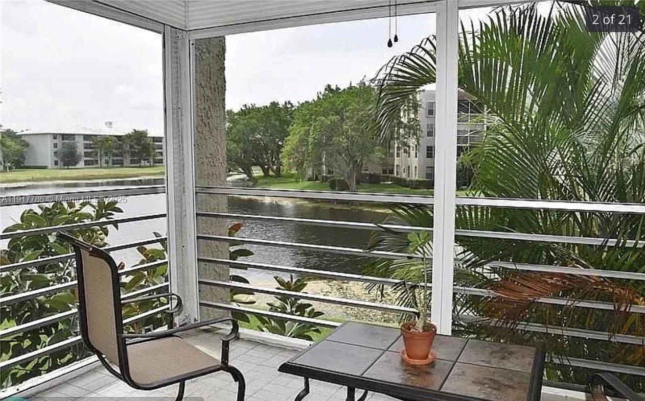 9230 Lagoon Place, Unit 215 Davie, FL 33324 - Photo 2 of 19 a view of a chairs and table in the balcony