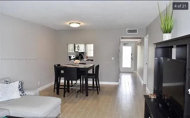 a dining room with furniture and window
