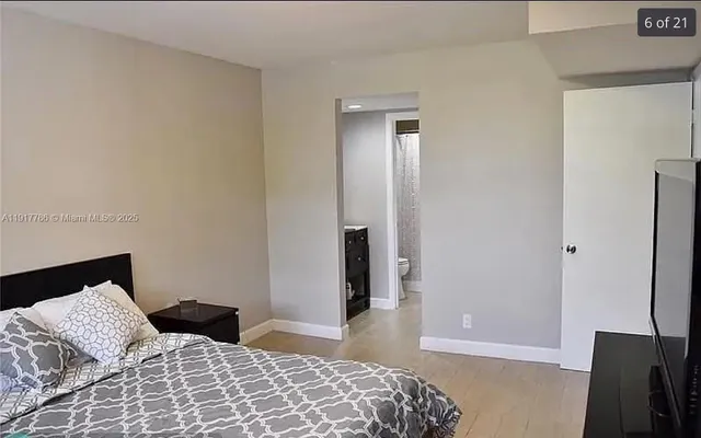 a bedroom with a bed and a flat screen tv