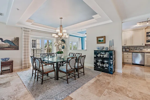 a view of a dining room with furniture and chandelier