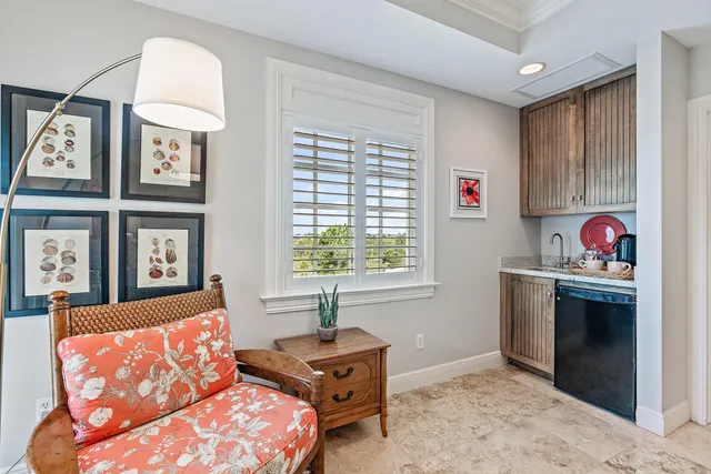 a living room with furniture a bed and a window