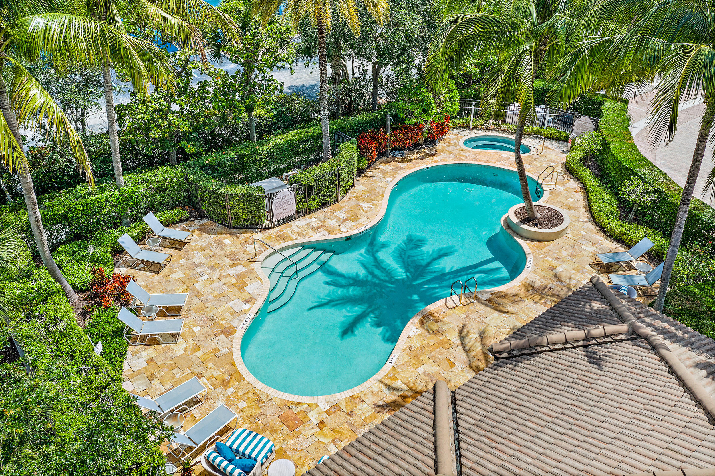 126 Tierra Lane, Unit 4 Jupiter, FL 33477 - Photo 22 of 45 a view of a swimming pool with lounge chair
