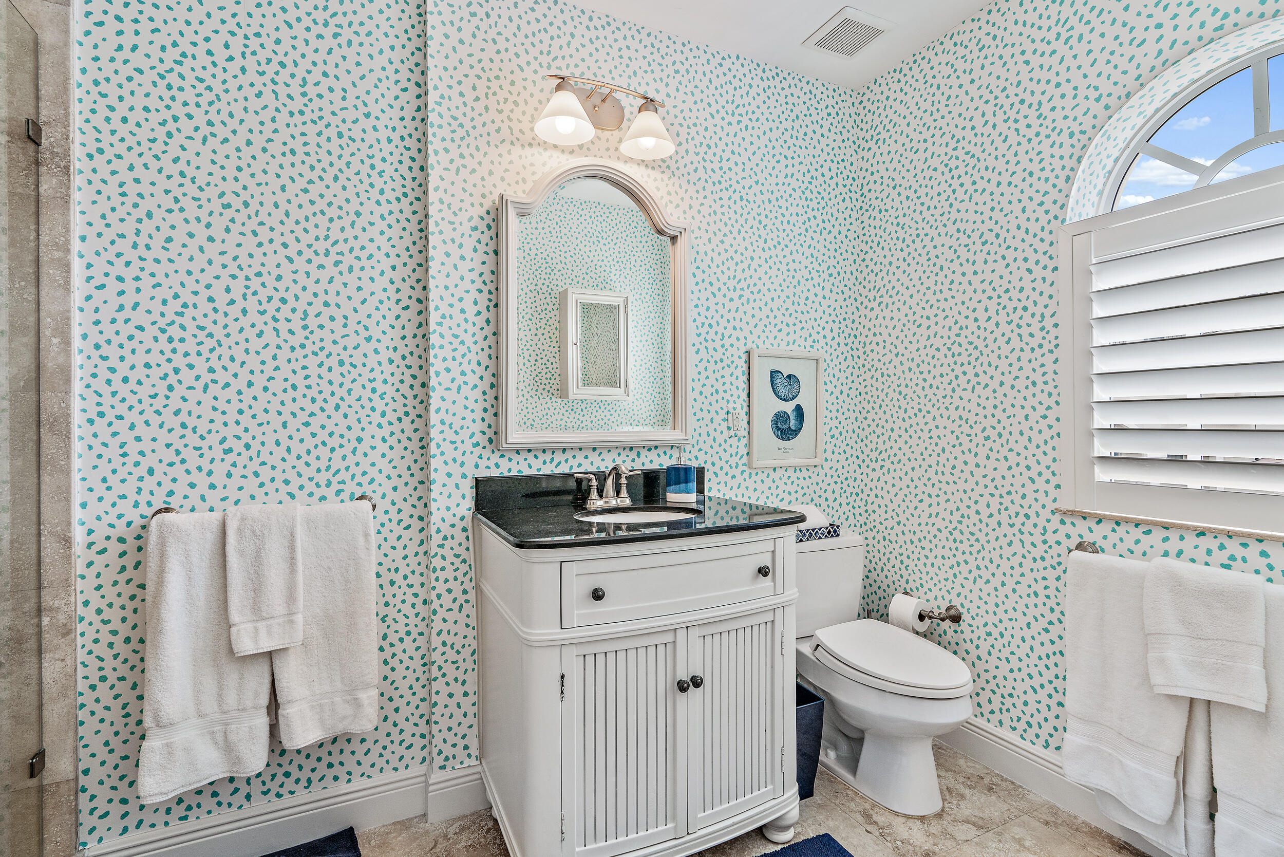 126 Tierra Lane, Unit 4 Jupiter, FL 33477 - Photo 24 of 45 a bathroom with a toilet a sink and mirror